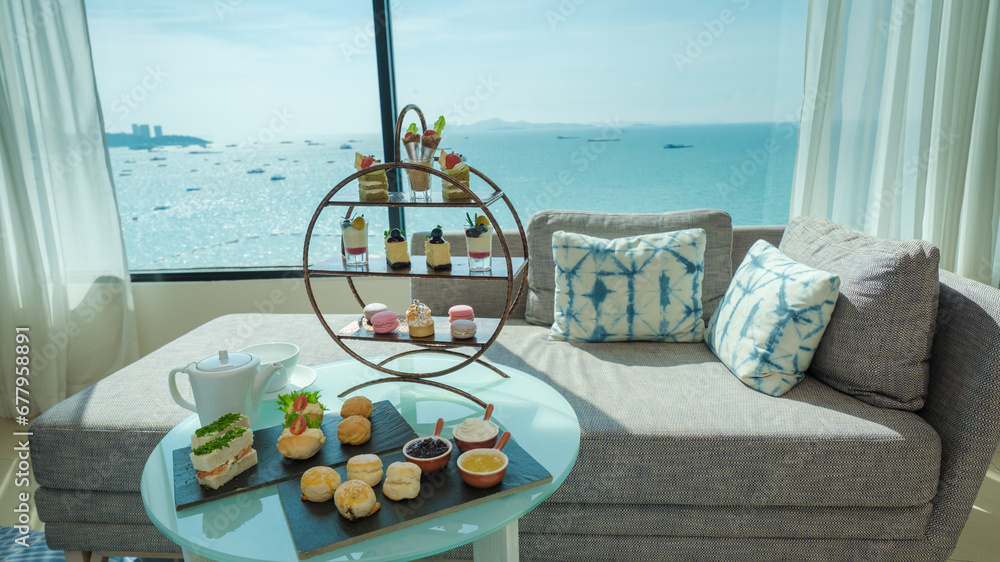 afternoon tea or high tea in a hotel room with bright fresh colors, a minimal style bedroom with an ocean view - obrazy, fototapety, plakaty 