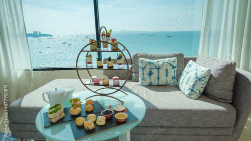 afternoon tea or high tea in a hotel room with bright fresh colors, a minimal style bedroom with an ocean view