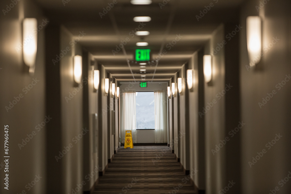 Empty long passage in a building from which doors lead into rooms.
