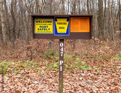 Three Pennsylvania Game Commission signs in the parking lot of State Game Lands 47 in Venango County, Pennsylvania, USA on a sunny fall day