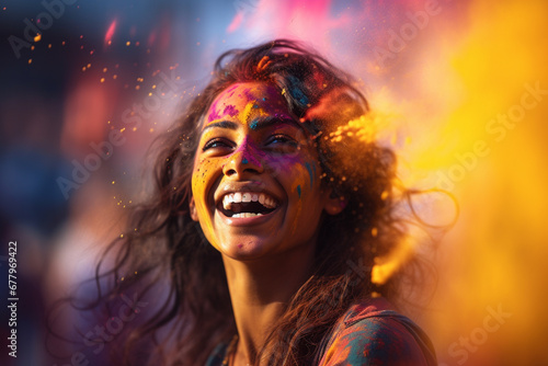 happy indian woman with holi powder on her face at holi festival bokeh style background © toonsteb