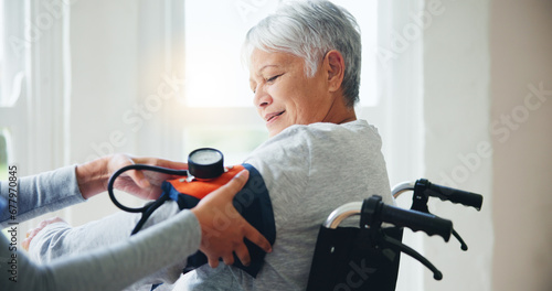Woman, doctor and senior in wheelchair for blood pressure, monitoring or elderly care at old age home. Nurse or medical caregiver checking BPM of mature patient or person with a disability at house