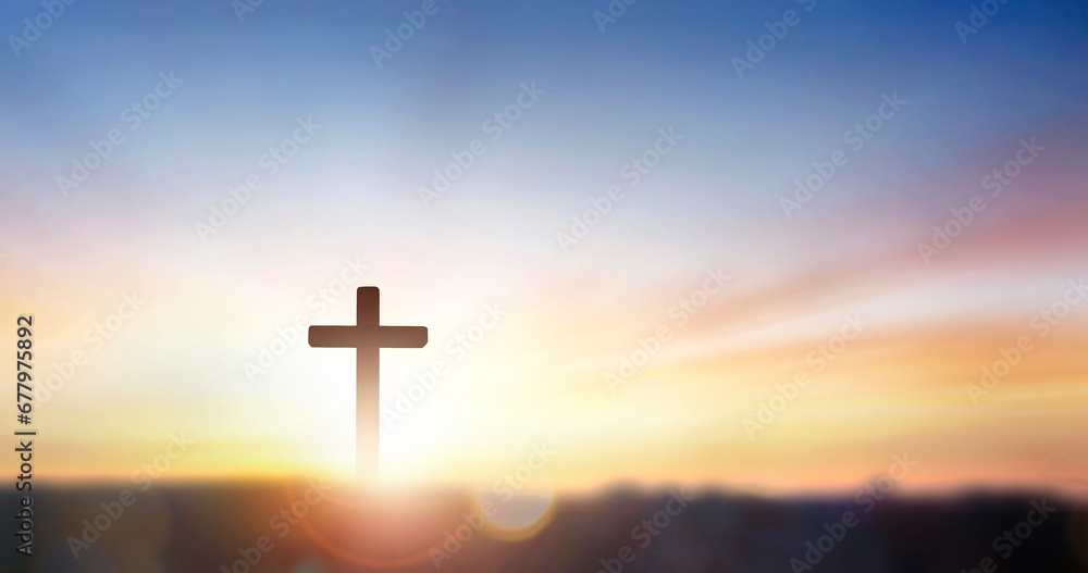 christian cross on hill outdoors at sunrise