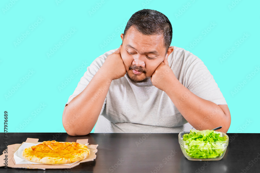 Portrait of overweight person looks confused and thinking to choose salad or pizza Portrait of overweight person looks confused and thinking to choose salad or pizza