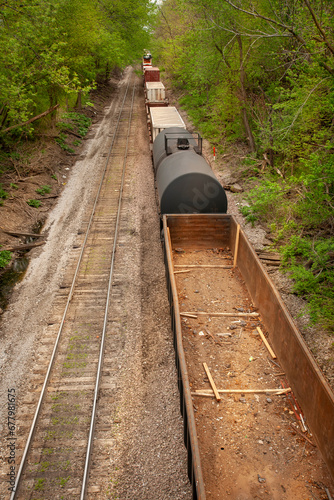 Above view of empty train cars and container rail cards on tracks in a rural setting
