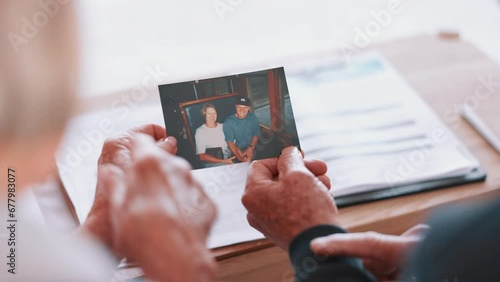 Photograph, memory and old couple in home remember date, event and marriage with nostalgia. Elderly people back, hands and photography as a reminder of life in vintage picture and thinking of history photo