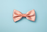 Peach pink bow tie on pastel blue background