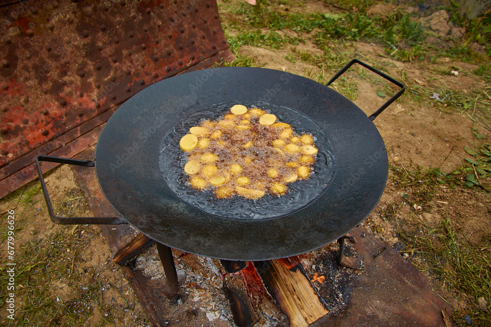 fried potatoes in oil in the cauldron