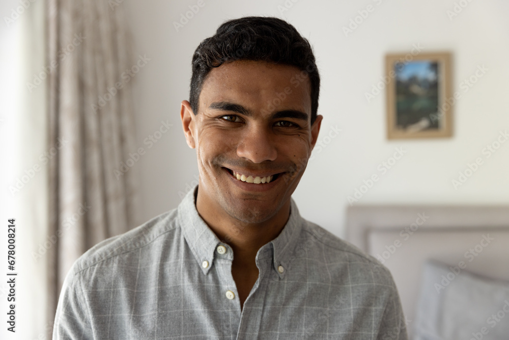 Portrait of happy biracial man standing in bedroom at home Portrait of happy biracial man standing in bedroom at home