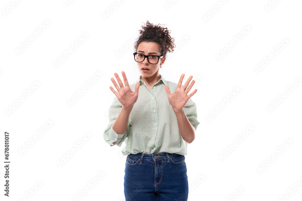 young surprised brunette woman with glasses shows her hands on a white background in copy space young surprised brunette woman with glasses shows her hands on a white background in copy space