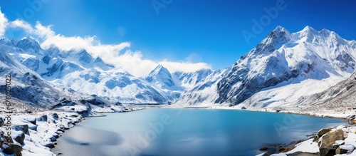 Panoramic view of snow-capped mountains and lake in Himalayas, Nepal photo