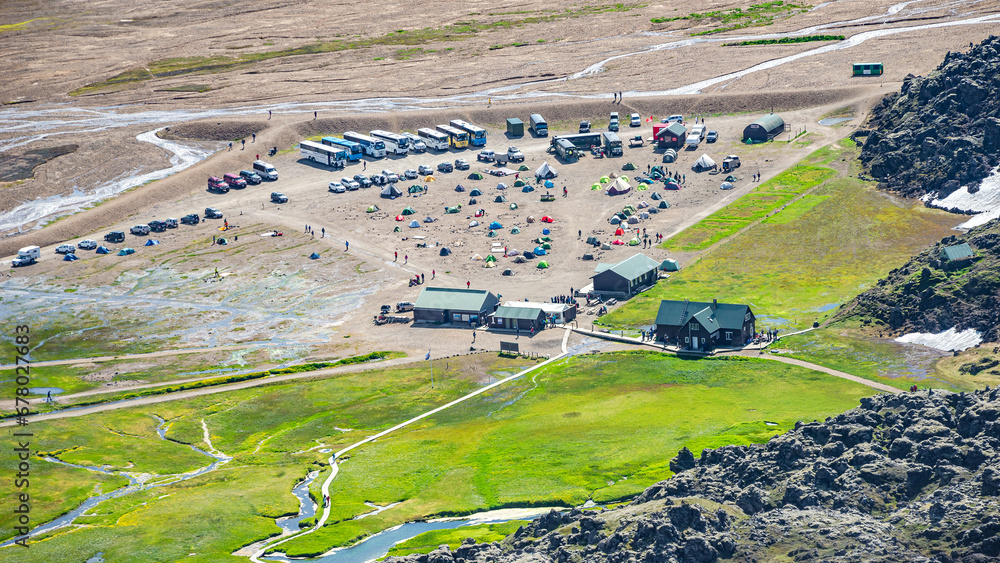Landmannalaugar, Iceland. Bird view at camping site and mountain hut with many tents and cars, Icelandic landscape of colorful rainbow volcanic mountains at Laugavegur hiking trail