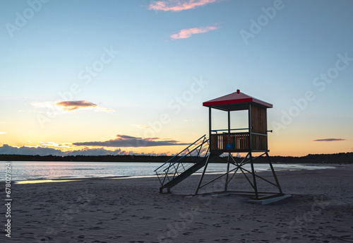 view of a lifeguard deck on the shore of the sea at sunset time © Cavan