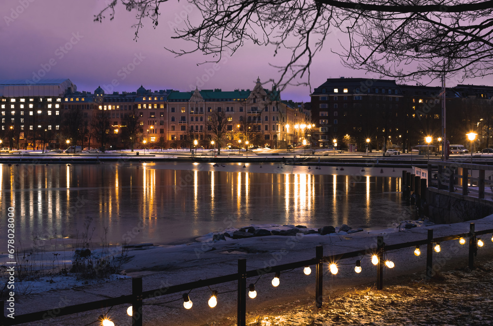 Helsinki evening street with yellow lights on the shore of the bay