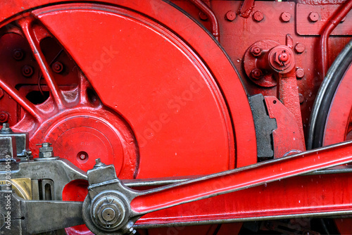 Close-up of a steam locomotive wheel with linkage