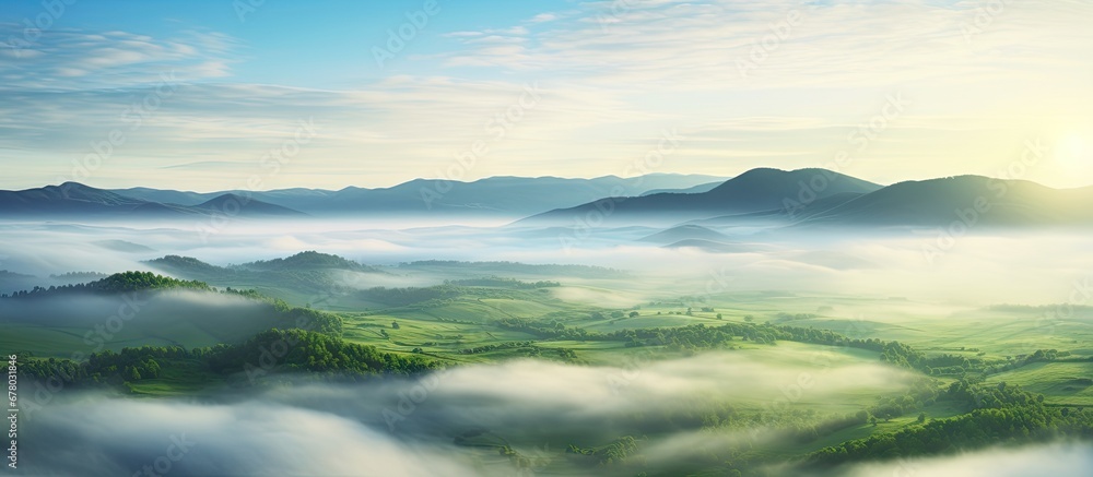 Europe s stunning aerial view of a green field at sunrise obscured by enchanting fog Copy space image Place for adding text or design