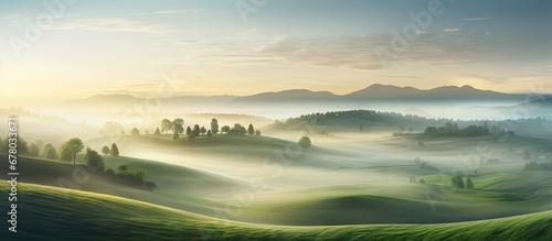 Fototapeta Naklejka Na Ścianę i Meble -  Europe s stunning aerial view of a green field at sunrise obscured by enchanting fog Copy space image Place for adding text or design