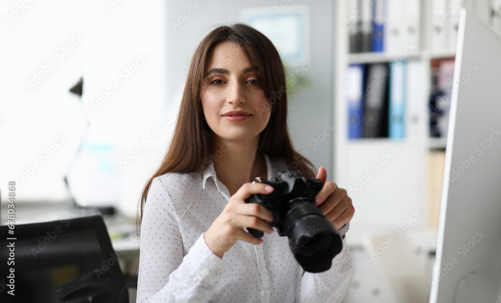 Portrait of pretty businesslady with modern camera. Wonderful woman looking with gladness and joyfulness . Business and art design concept. Blurred background
