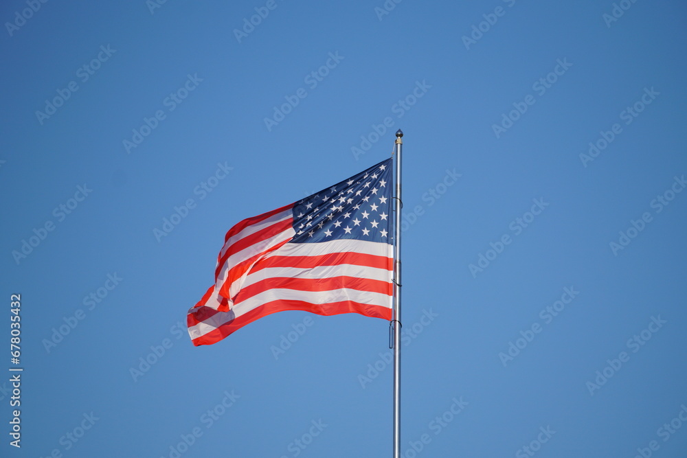 American Flag . USA national flag waving on wind against blue sky. Slow motion American Flag . USA national flag waving on wind against blue sky. Slow motion