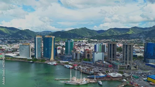 Hyperlapse aerial view of the vibrant Caribbean city of Port of Spain, Trinidad and Tobago with an amazing cloudscape in the background photo