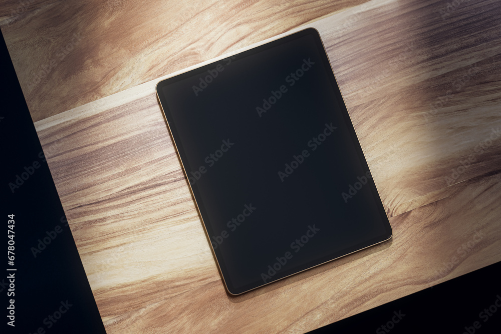 Top view of empty black tablet on wooden table. Mock up, 3D Rendering. Top view of empty black tablet on wooden table. Mock up, 3D Rendering.