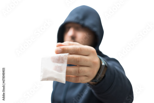 Criminal man in a hood holds transparent plastic bag with white powder hard drugs isolated on transparent background, drug dealer or gangster sells narcotics photo