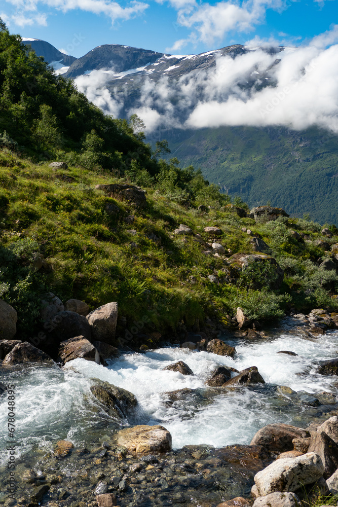 Water flowing down the mountain into the Fjord in Norway Water flowing down the mountain into the Fjord in Norway