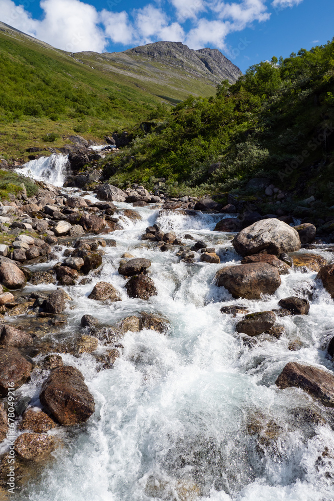 Water flowing down the mountain into the Fjord in Norway Water flowing down the mountain into the Fjord in Norway