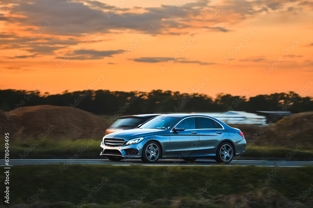 Luxury premium sport car on the road. Expensive executive vehicle in action. Luxury premium sport car on the road. Expensive executive vehicle in action.