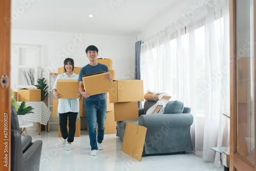 Asian young happy new married couple moving to their new house or real estate. © ijeab