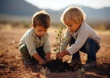 Dos hermanos plantando un pequeño arbol en un terreno desertico cuidando el medio ambiente