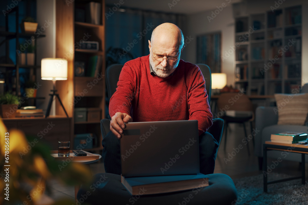 Senior man using a laptop at home