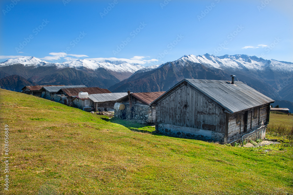 Highland houses made of stone and wood. Wooden plateau houses built on the hill. Historical highland houses. Sal Plateau Rize. Wooden plateau houses in Turkey. Sal Plateau Rize Türkiye.	