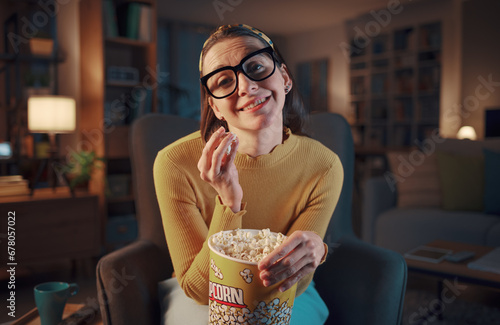 Fotografi Woman watching romantic movies on TV