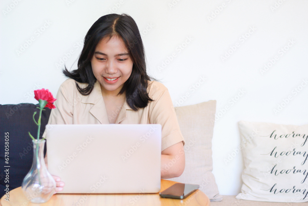 cheerful asian woman working on laptop sitting on cozy couch wearing casual stylish, female online shop owner cheerful asian woman working on laptop sitting on cozy couch wearing casual stylish, female online shop owner