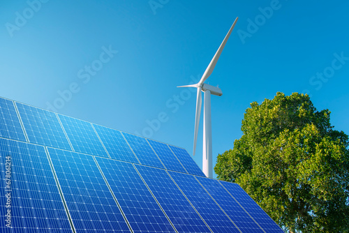 wind turbine with solar panels in  blue sky. concept of clean energy. Energy supply, wind turbine, eolic turbine, distribution of energy, Powerplant, energy transmission, high voltage supply concept