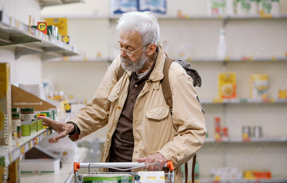 Senior man doing grocery shopping and empty shelves