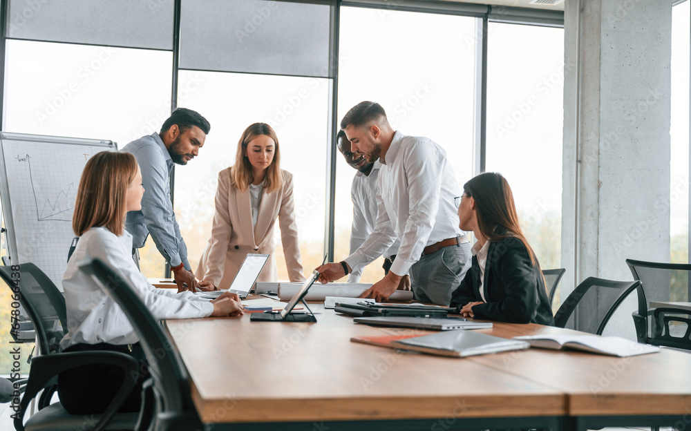In the modern office. Group of workers are together indoors In the modern office. Group of workers are together indoors