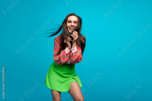 Photo of attractive hispanic lady posing camera shooting hair flying wearing blouse mini skirt isolated teal blue color background