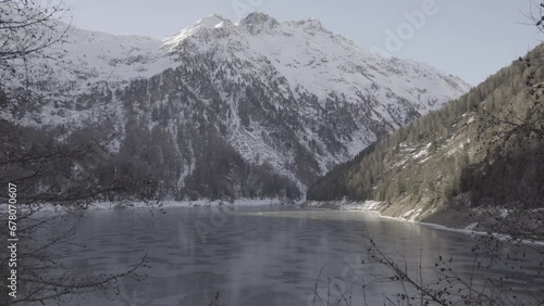 Frozen lake with mountains background (4k slog) photo