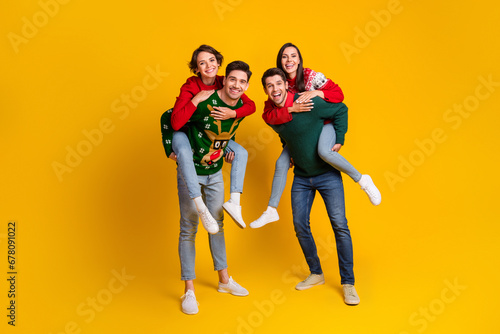 Photo of four best buddies people have fun on christmas event occasion piggyback isolated shine color background