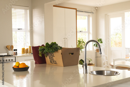Vegetables in cardboard box on worktop in kitchen