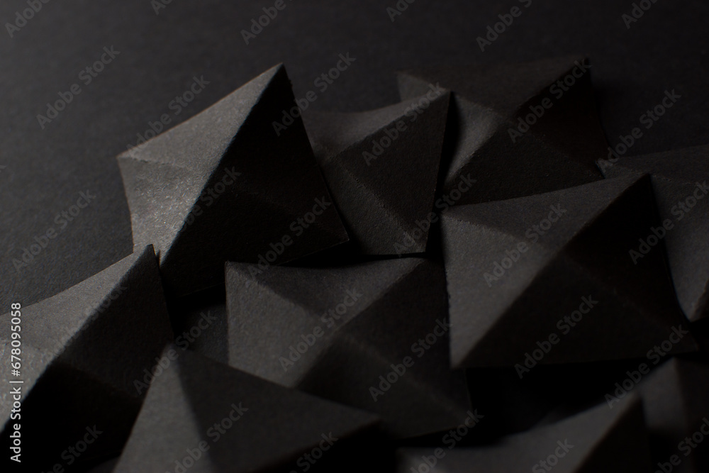 Fototapeta premium Black abstract background with geometric shapes, close up