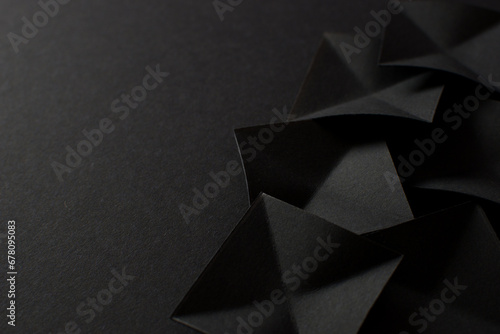 Black abstract background with black geometric shapes, copy space