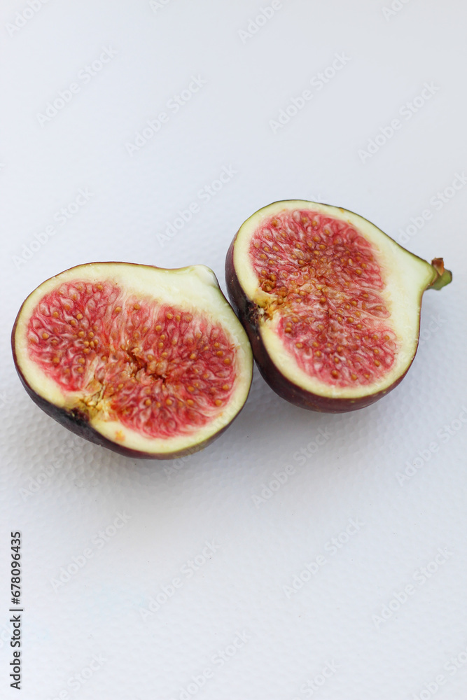Fig fruits cut on a plate, juicy ripe flesh with seeds