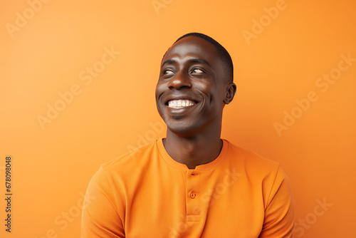 Medium shot portrait photography of a pleased man in his 30s against a light orange background