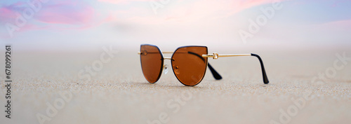 Sunglasses in the waves of the warm sea on vacation, a paradise beach and beautiful sunglasses in the waves of the warm sea.