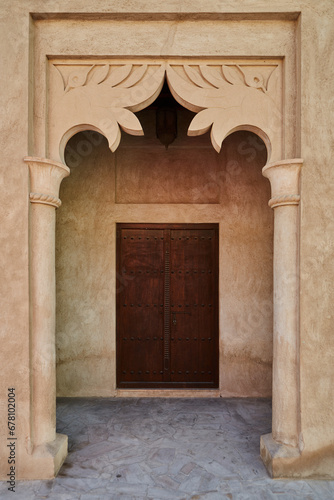 Front door and arch in old Arab house in Al Fahidi neighborhood, historic landmark in East Dubai