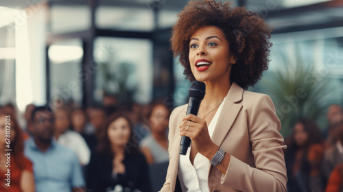 Black afro American businesswoman delivering a powerful keynote address at a conference standing on stage with confidence addressing a diverse audience with her insights in the business world