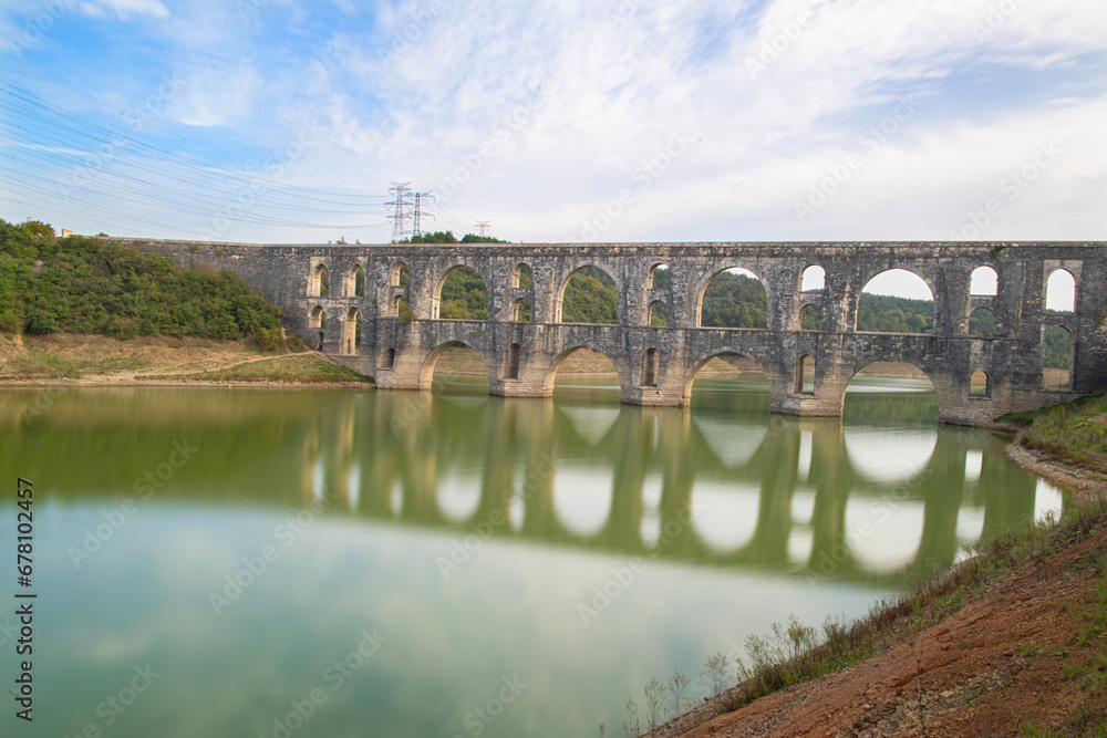 Fototapeta premium Maglova Aqueduct built by Mimar Sinan in Istanbul. Long exposure techniques on aqueduct columns. Reflections of the historical Aqueducts in Istanbul. Istanbul Türkiye.